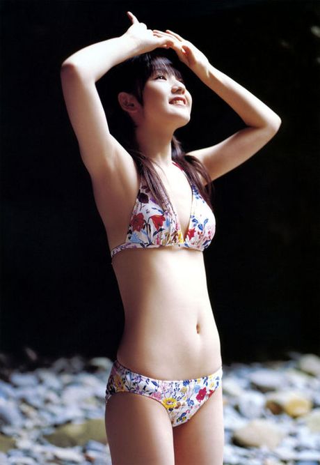 Two beautiful asian babes showing off their bodies in bikinis