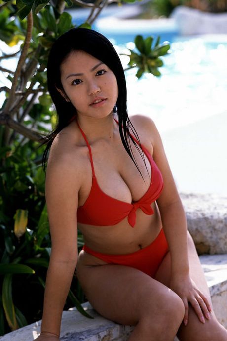 A tight skimpy red bikini holds in this idols big busty boobs