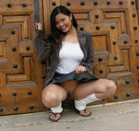 Asian schoolgirl with small tits strips and shows her pussy outdoors