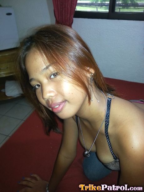 Asian teen Angel strips and shows her big melons and shaved pussy