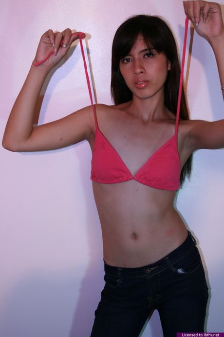 Skinny Asian babe strips off and bares her tiny tits and ass