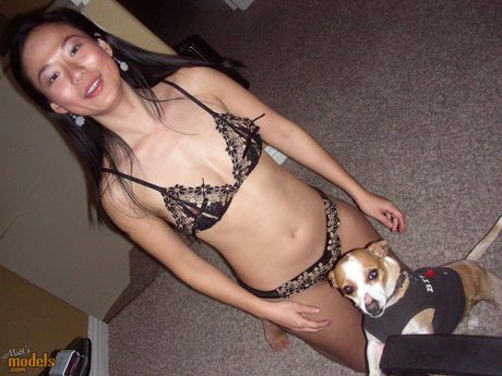 Asian cougar Niya Yu strips to her stockings and shows her big ass and tits