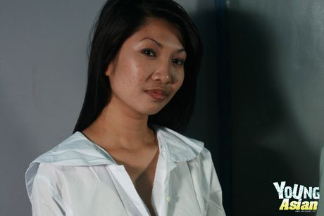 Asian schoolgirl with tiny tits strips off and unveils her pink pussy up close