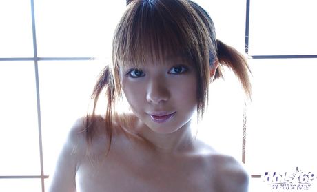 Shapely japanese teen Miyu exposes tiny tits and sissy