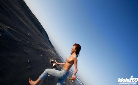Hot japanese teen Yu Satome in jeans shows big hooters and sexy butt at beach